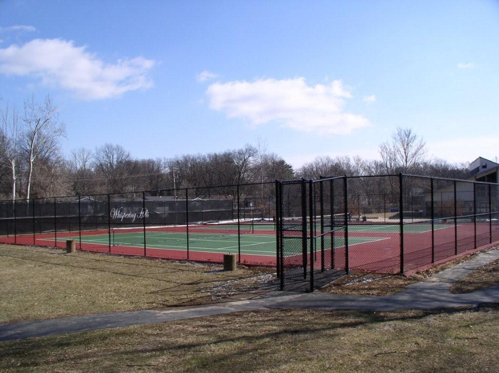 chain link fence surrounding a tennis court