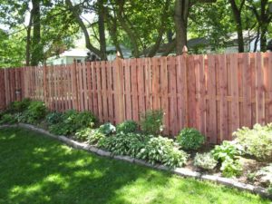 Gorgeous landscaping along wood fence