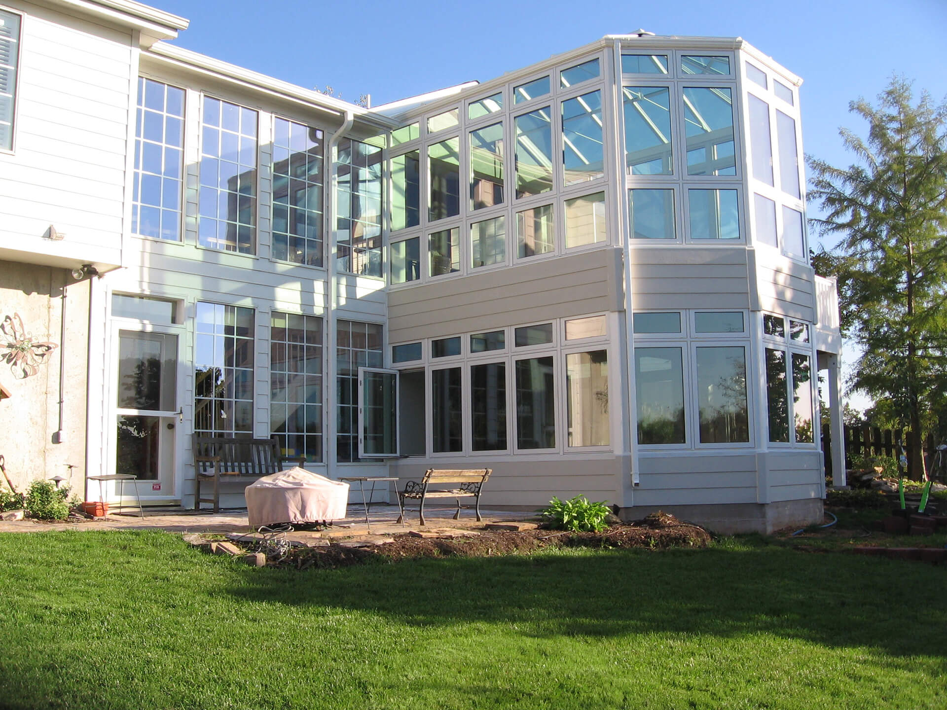 two-story sunroom on back of home