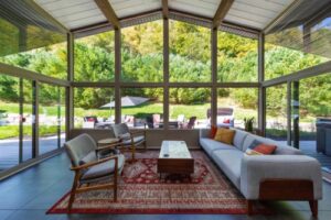 interior of Living Space sunroom with peaked ceiling and retro patio furniture