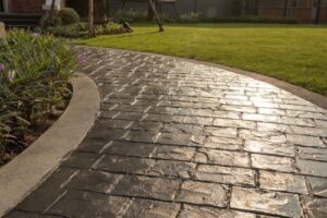 stamped concrete walkway winding through a yard near landscaping
