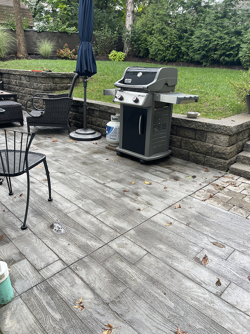 Stamped concrete patio with a retaining wall