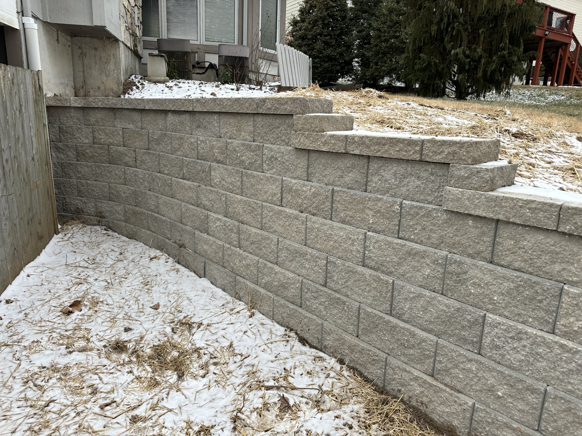 gray retaining wall on the side of a house in winter