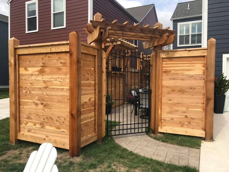 Wood pergola with surrounding fence and gate