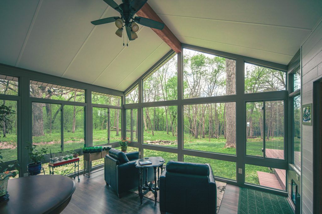 Sunroom with windows on all sides and a dog door in St. Louis