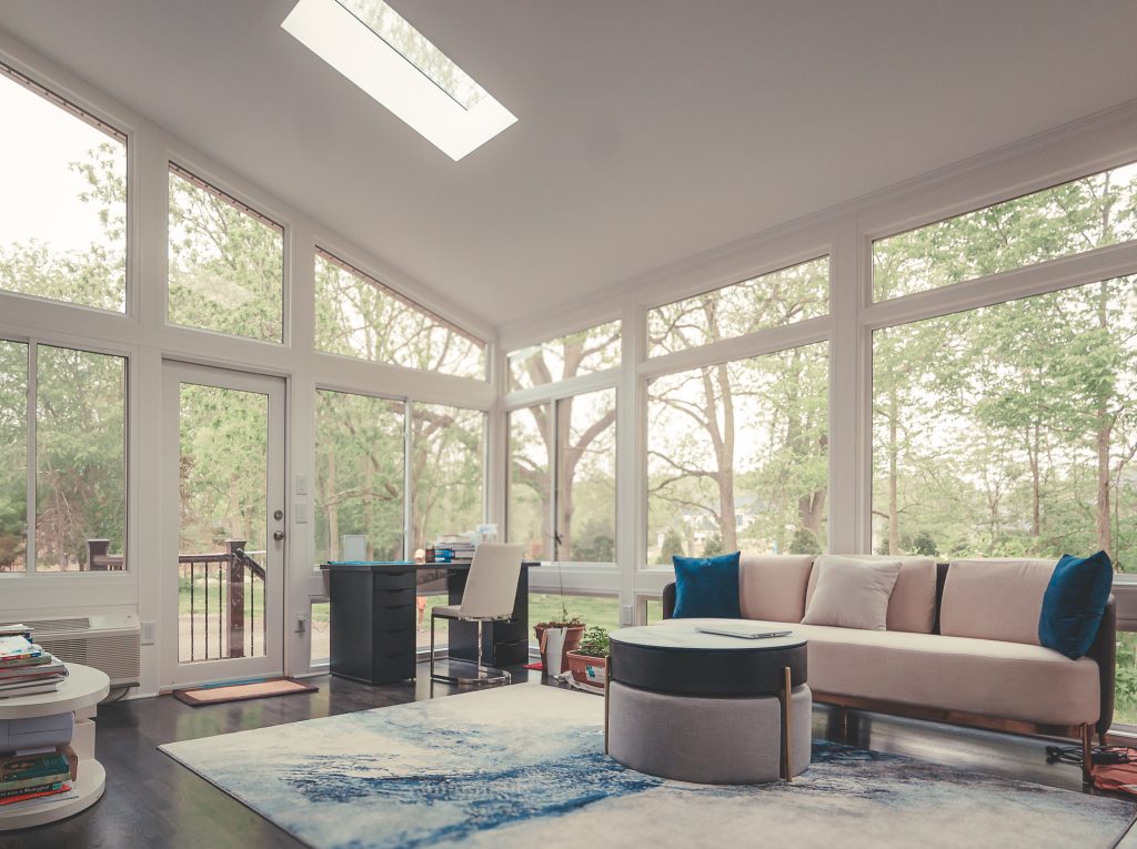 Cozy sunroom with skylight and comfortable every day living furniture