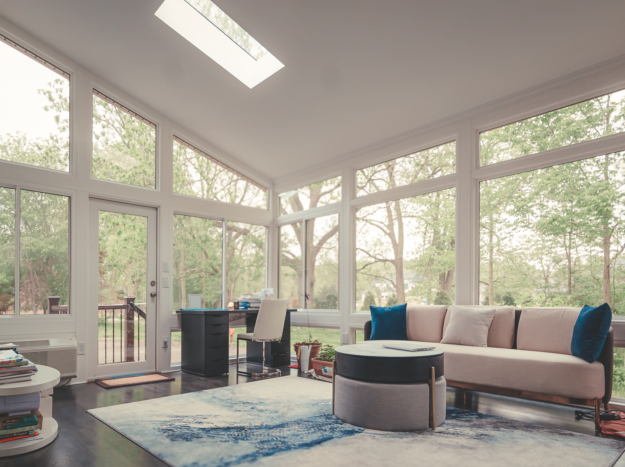 Cozy sunroom with skylight and comfortable every day living furniture