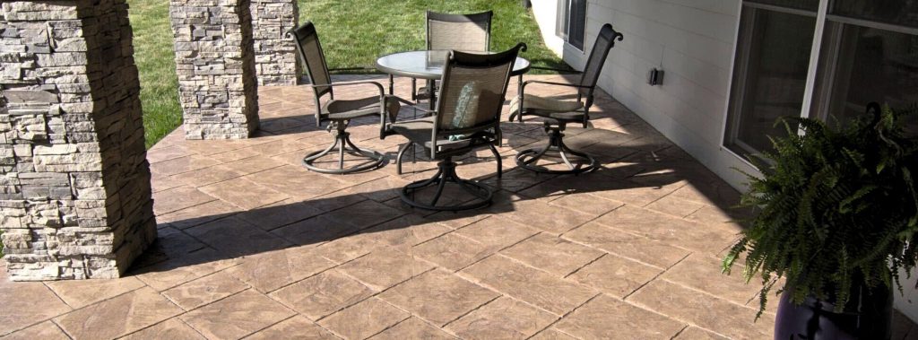 Stamped concrete patio under a deck 