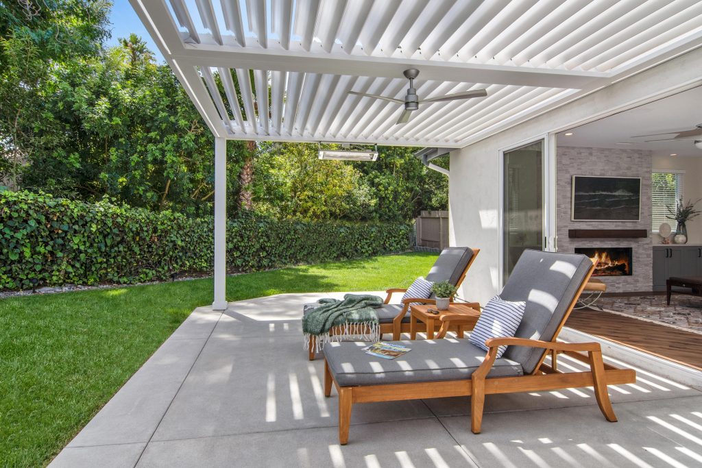 Louvered roof in backyard seating area