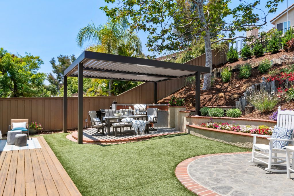 Louvered roof in a garden backyard entertainment space with dining