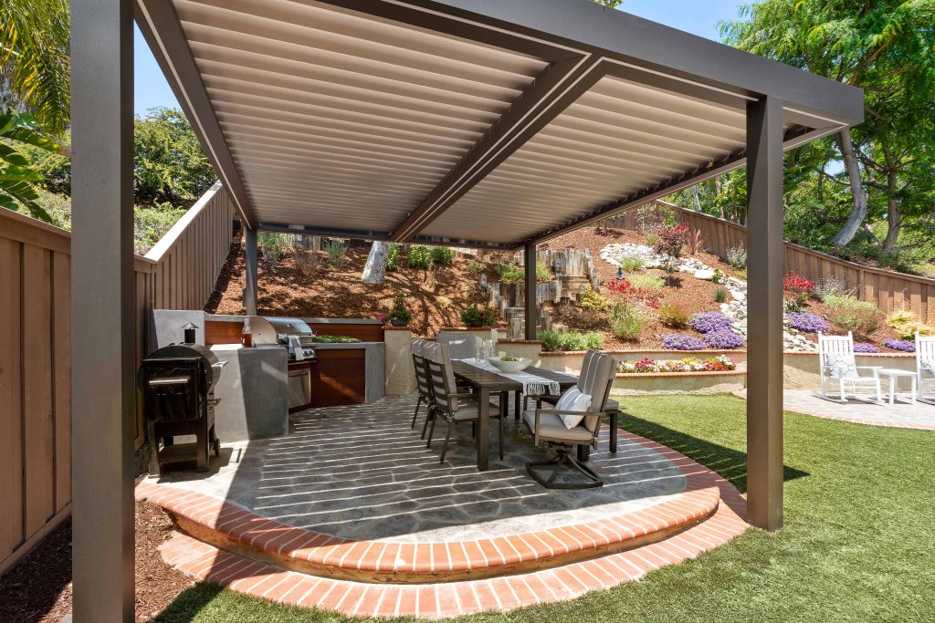 Louvered roof in a garden backyard entertainment space with dining