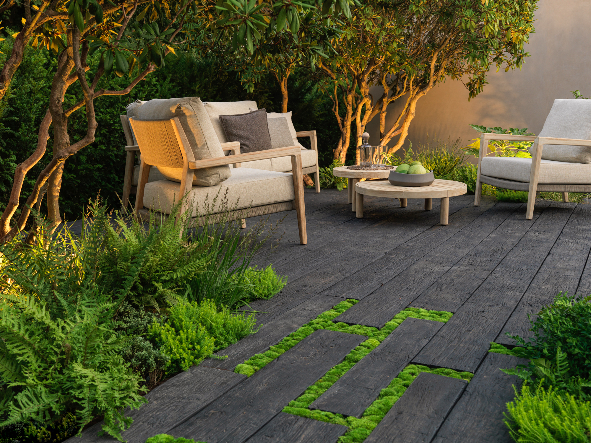 Textured oak millboard decking with greenery