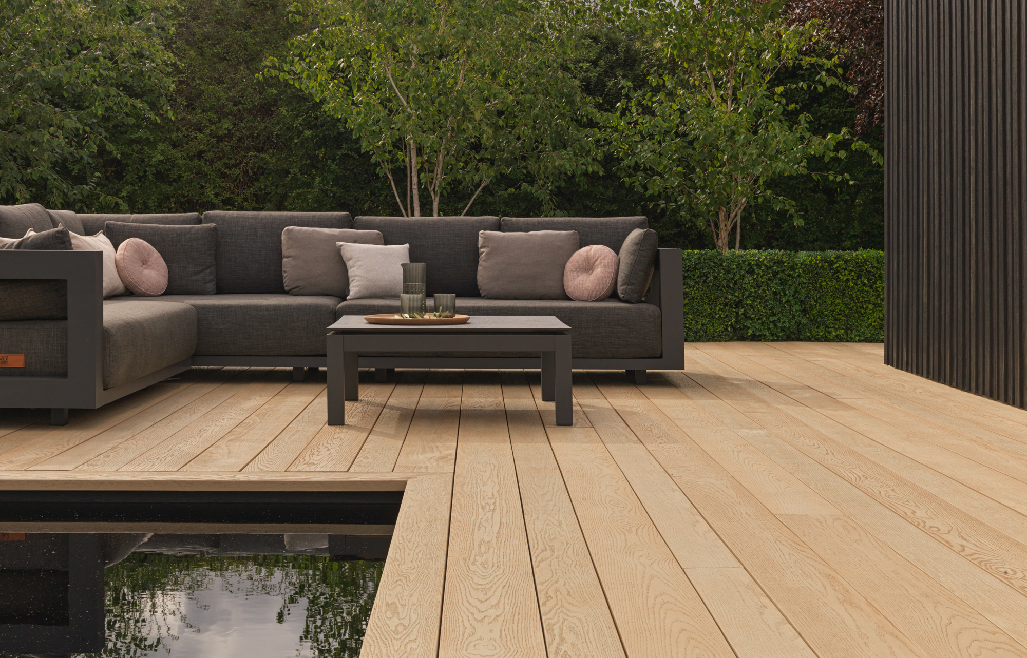 Composite decking with an outdoor living space with couches and a table