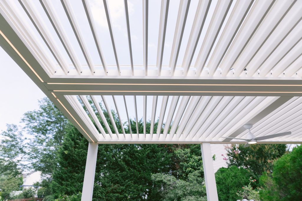 Louvered roof in backyard seating area
