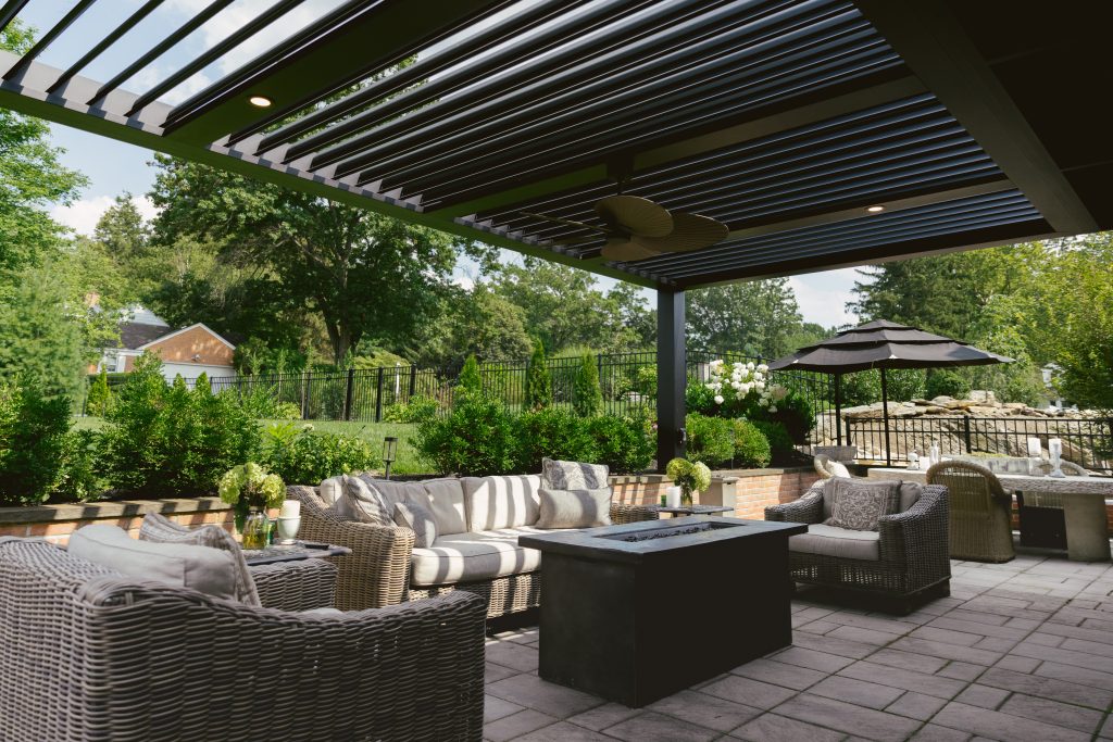 Black Louvered Roof in outdoor living area with seating and dining