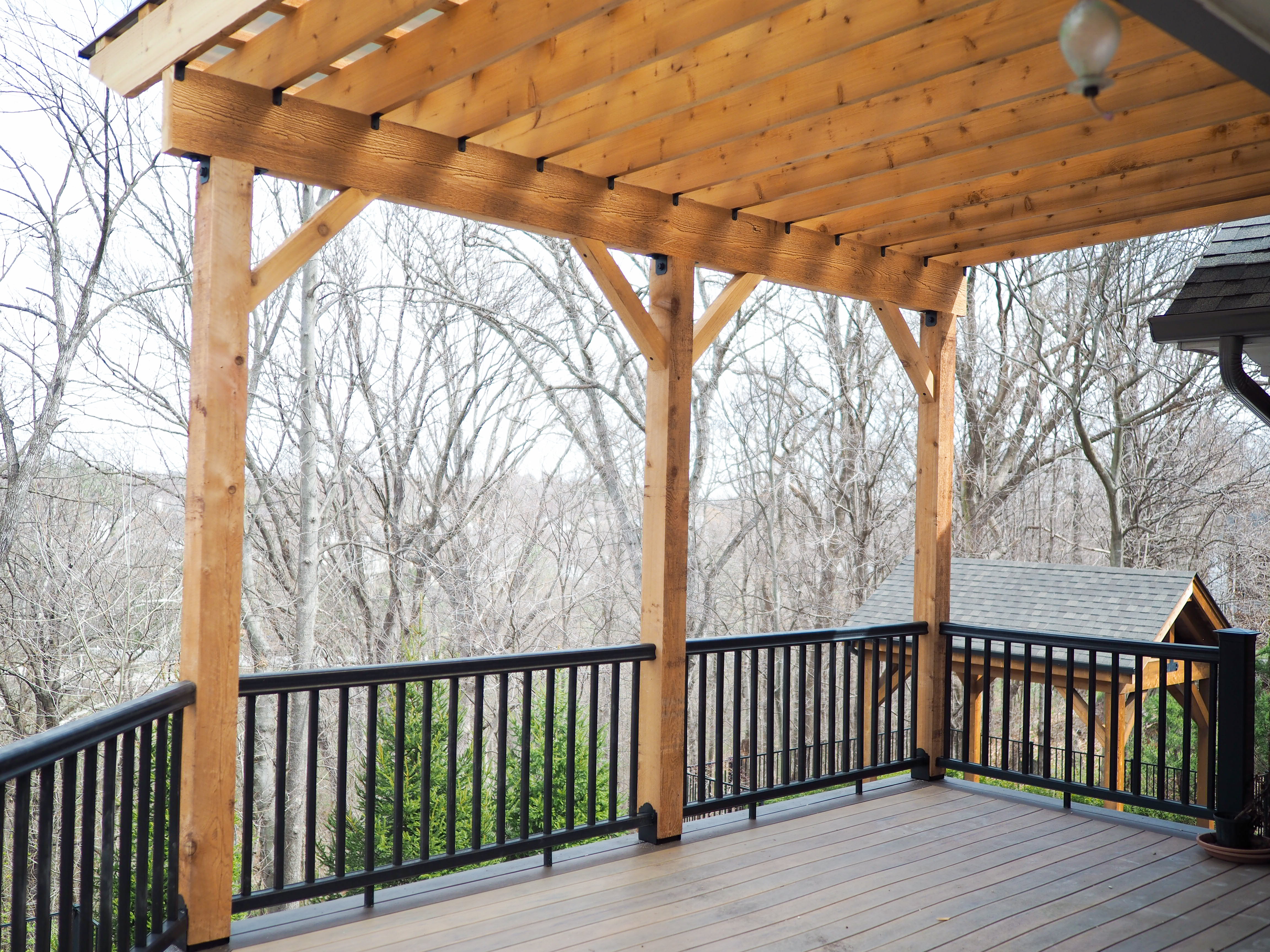 Hercules Roof Pergola on a deck with black railings