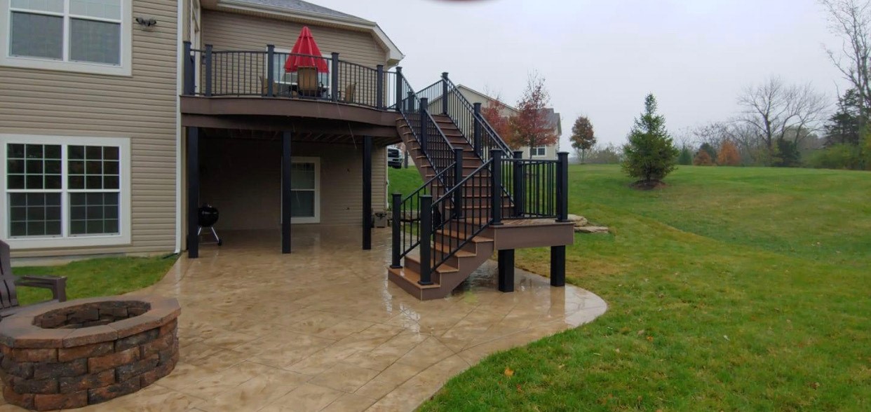 Stamped patio below and surrounding backyard deck