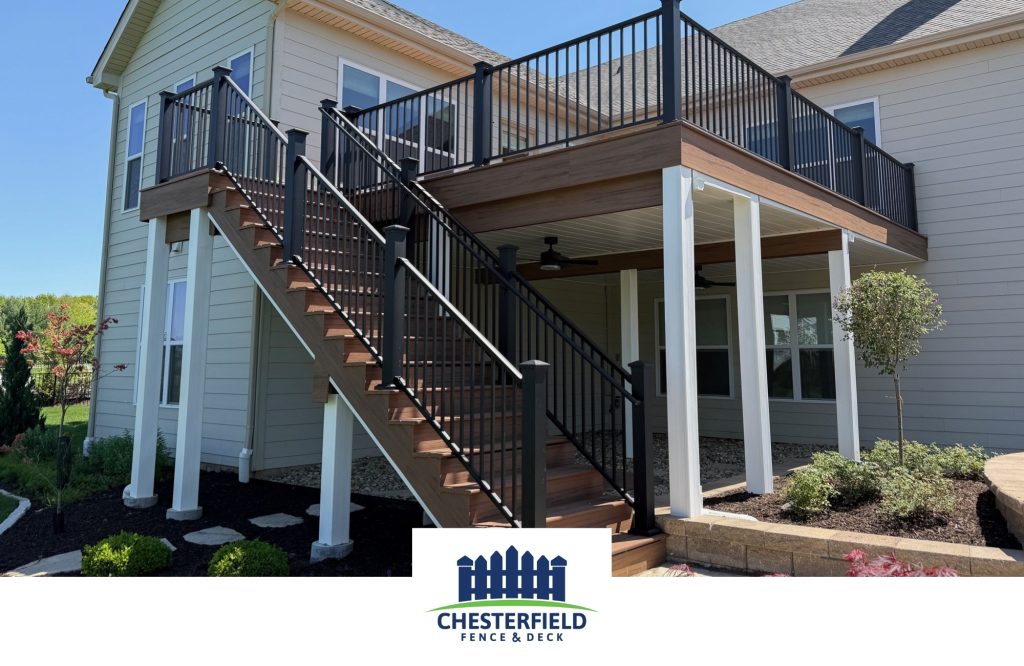 Deck with black railings and brown deck boards with white posts and an underdeck with the chesterfield fence and deck logo.